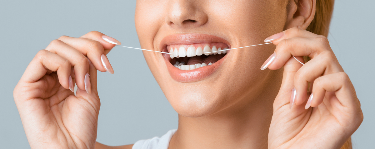 woman flossing teeth