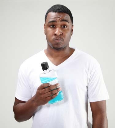 Man holding mouthwash bottle